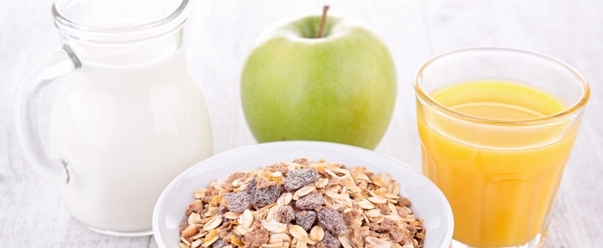 breakfast with cereal, milk and orange juice