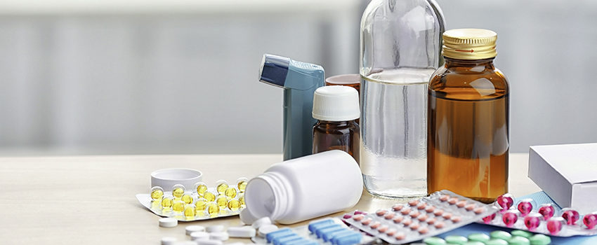 Different medicines and pills on wooden table