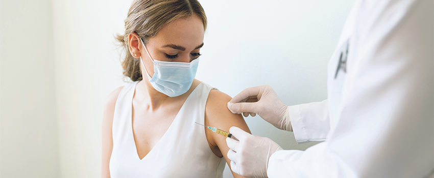 Cleaning up patient's arm for a vaccine