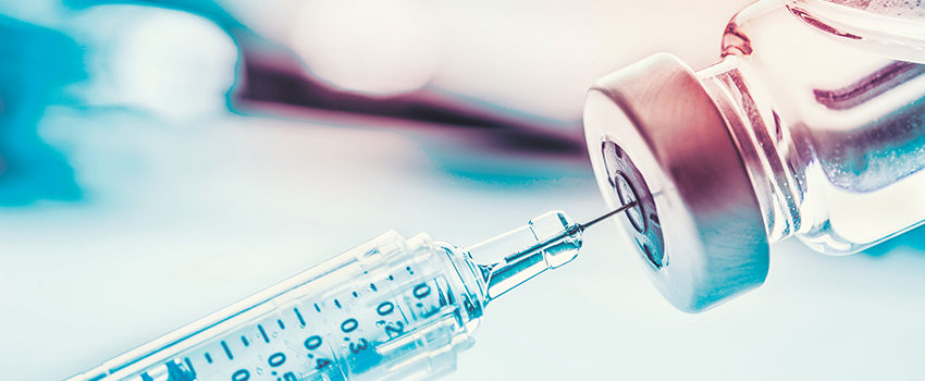 Close-up medical syringe with a vaccine.