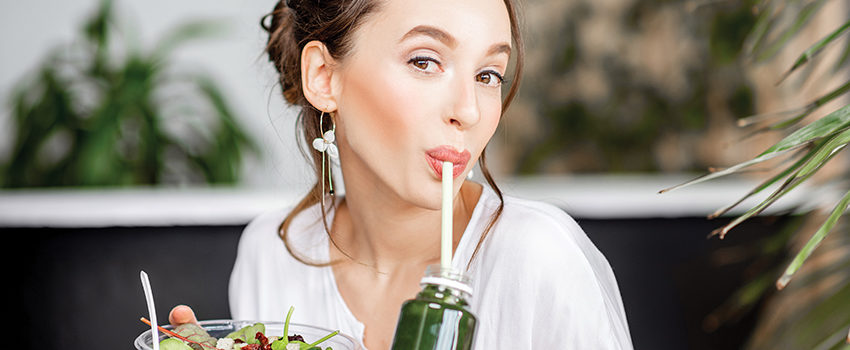 Beautiful woman with healthy food indoors