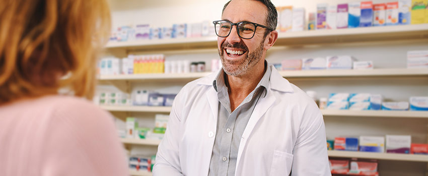 Helpful pharmacist dealing with a woman customer