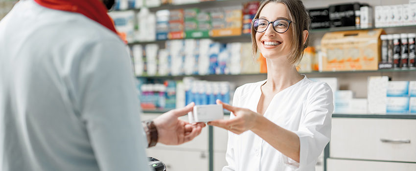 Pharmacist selling medications in the pharmacy store